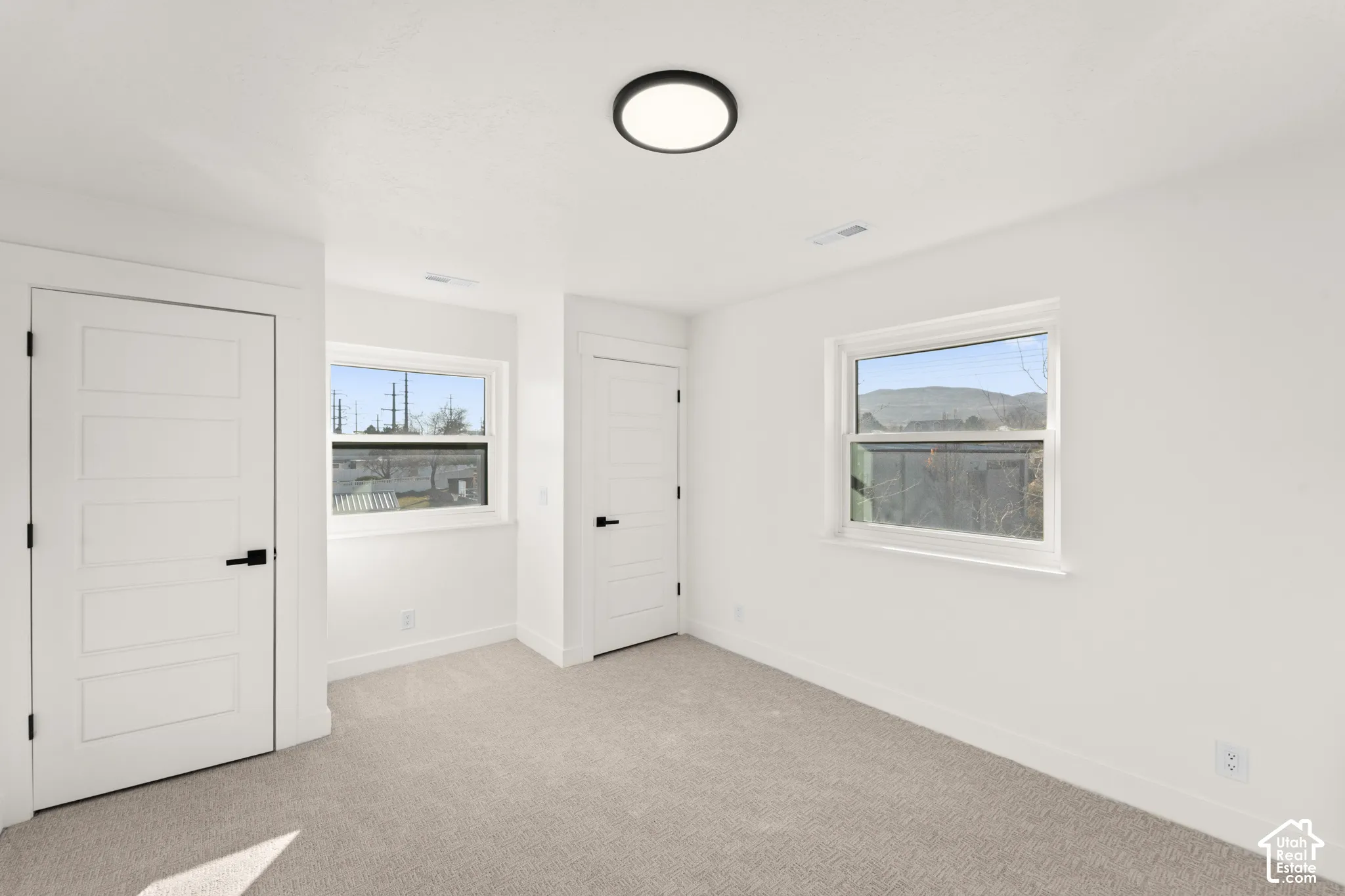 Light neutral carpeting and white walls