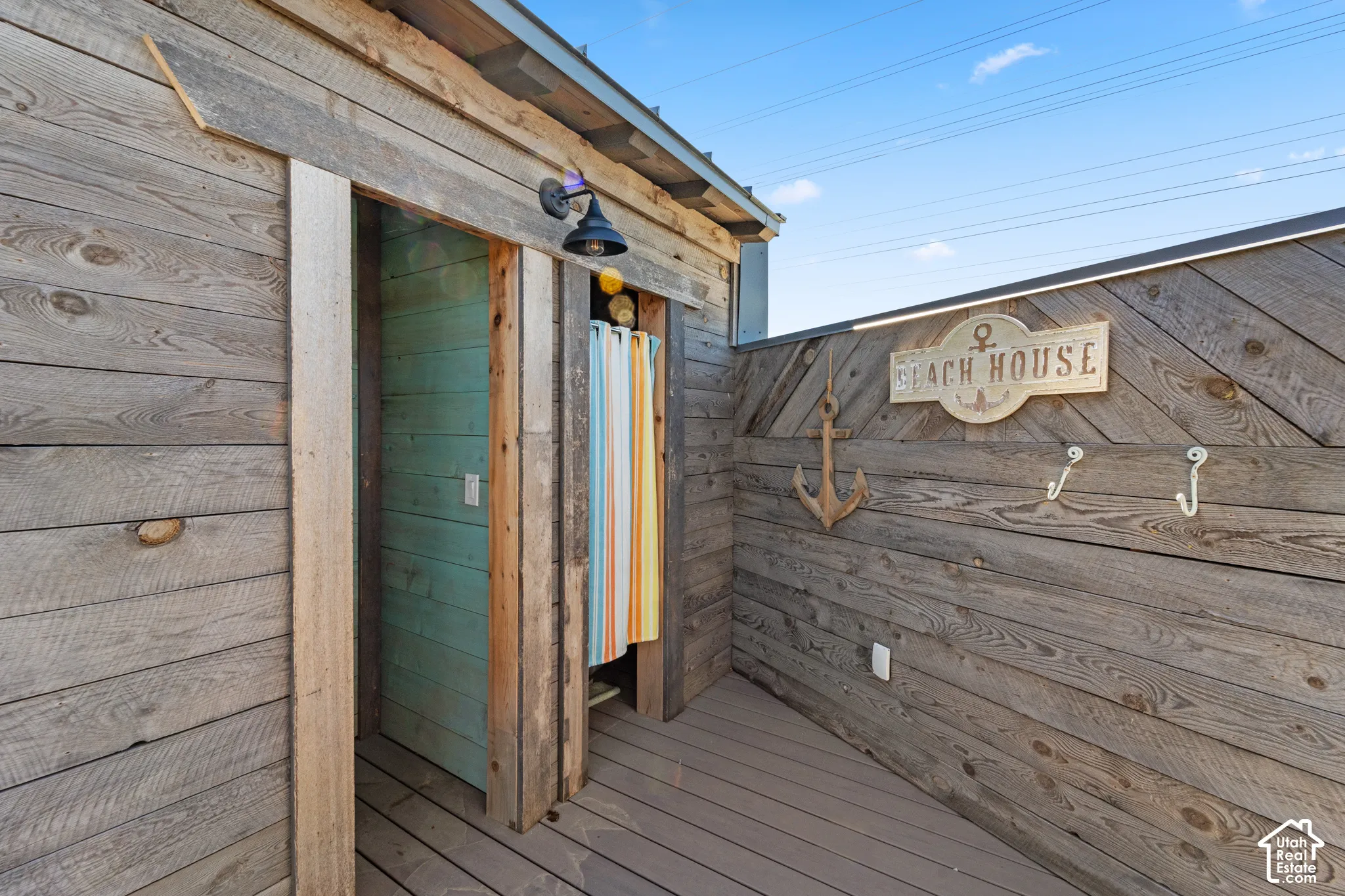 Wood-plank exterior wall with integrated recessed lighting
