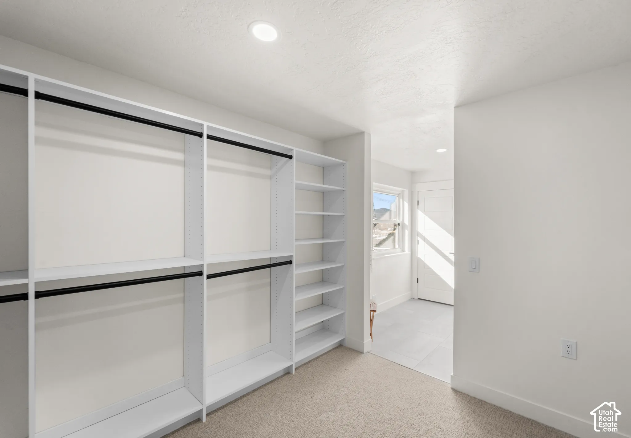Built-in closet system with shelving and hanging rods