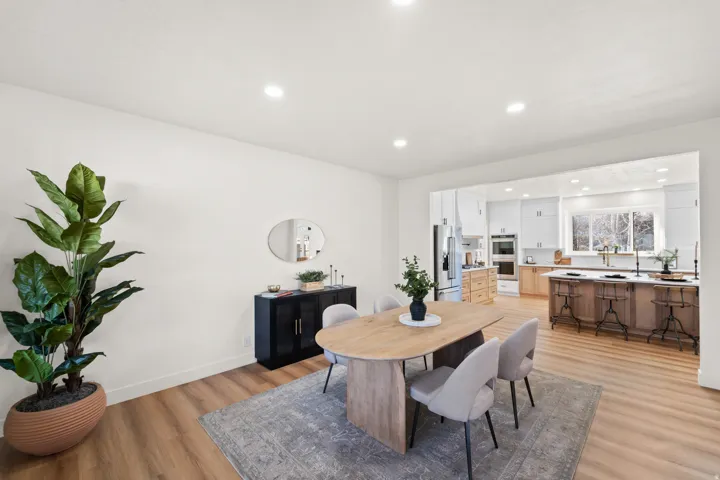 Recessed lighting illuminates the open-concept space featuring wood-finish flooring