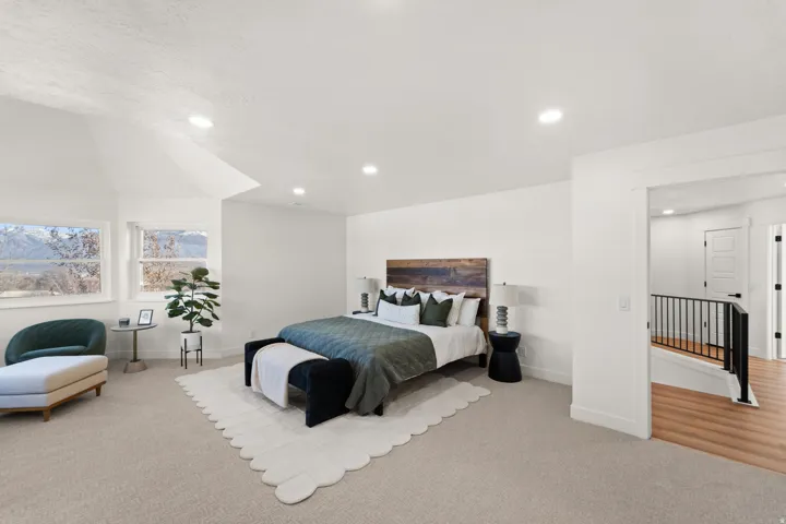 Vaulted ceiling, recessed lighting, carpet flooring, multiple windows, wood-finish flooring