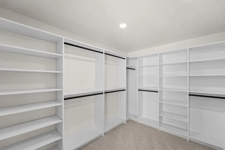 Built-in closet system with shelving and hanging rods