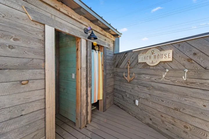 Wood-plank exterior wall with integrated recessed lighting