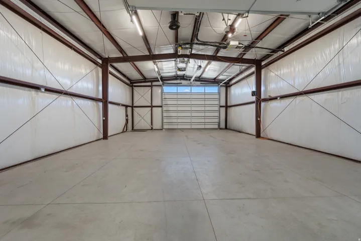 Spacious interior with concrete flooring and exposed metal beam construction