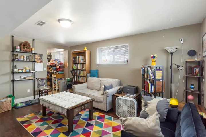 Recessed window, wood-finish flooring, built-in shelving, ceiling-mounted light fixture, neutral wall color