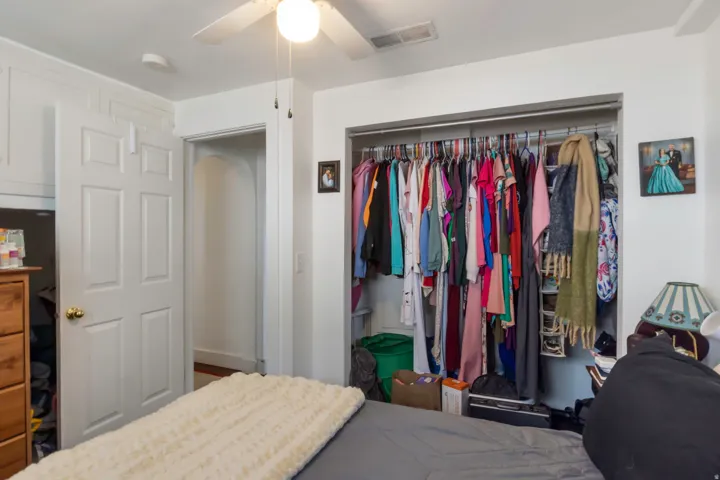 Recessed lighting, ceiling fan, built-in closet with hanging rod, paneled interior door, and trim detailing