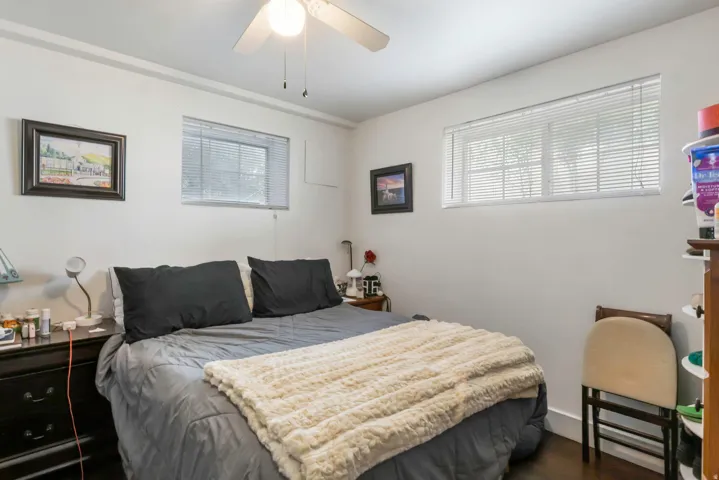 White walls with dark wood-finish flooring