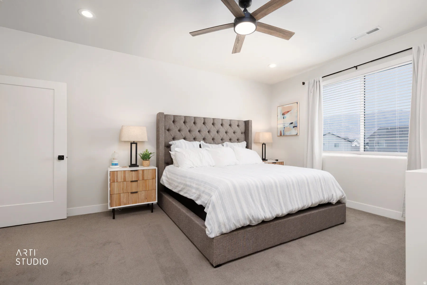 Recessed lighting, ceiling fan with light, broad window with blinds, solid core door with black hardware, and carpeted flooring