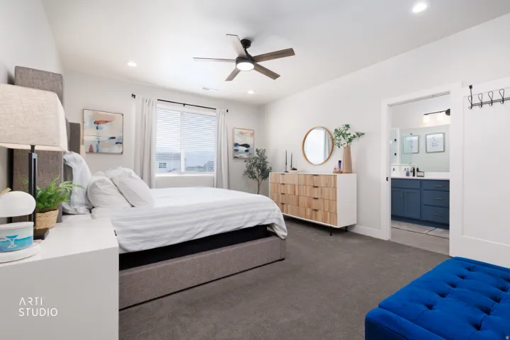 Recessed lighting, ceiling fan, carpet flooring, a window with blinds, and a barn door entry to a bathroom