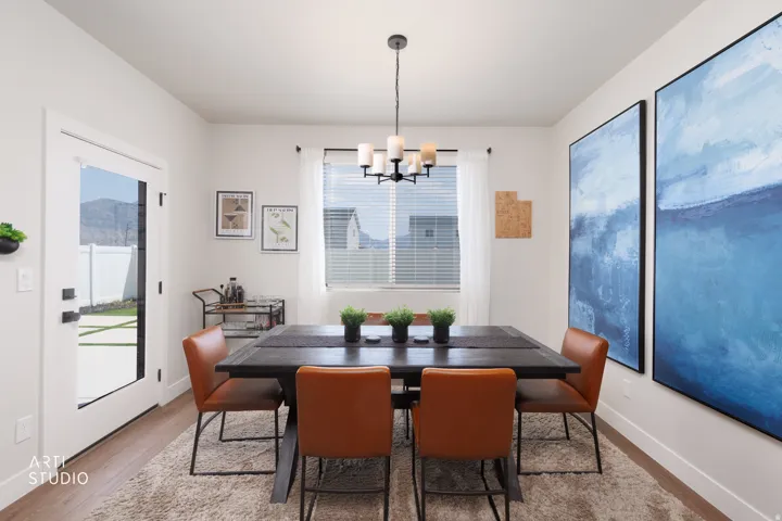 Wood-finish flooring, white walls, and a contemporary chandelier