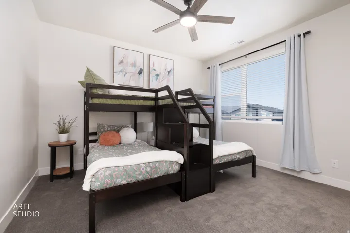 Room featuring gray carpeting, white walls, a ceiling fan with integrated lighting, and a large window with blinds