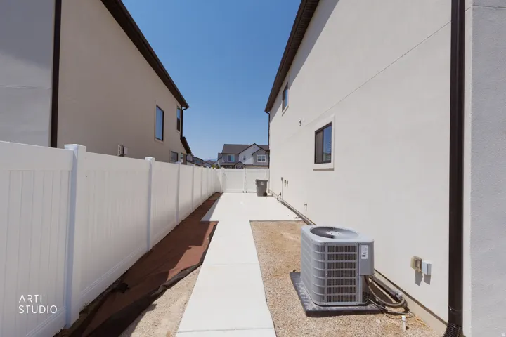 White vinyl privacy fencing with concrete walkway