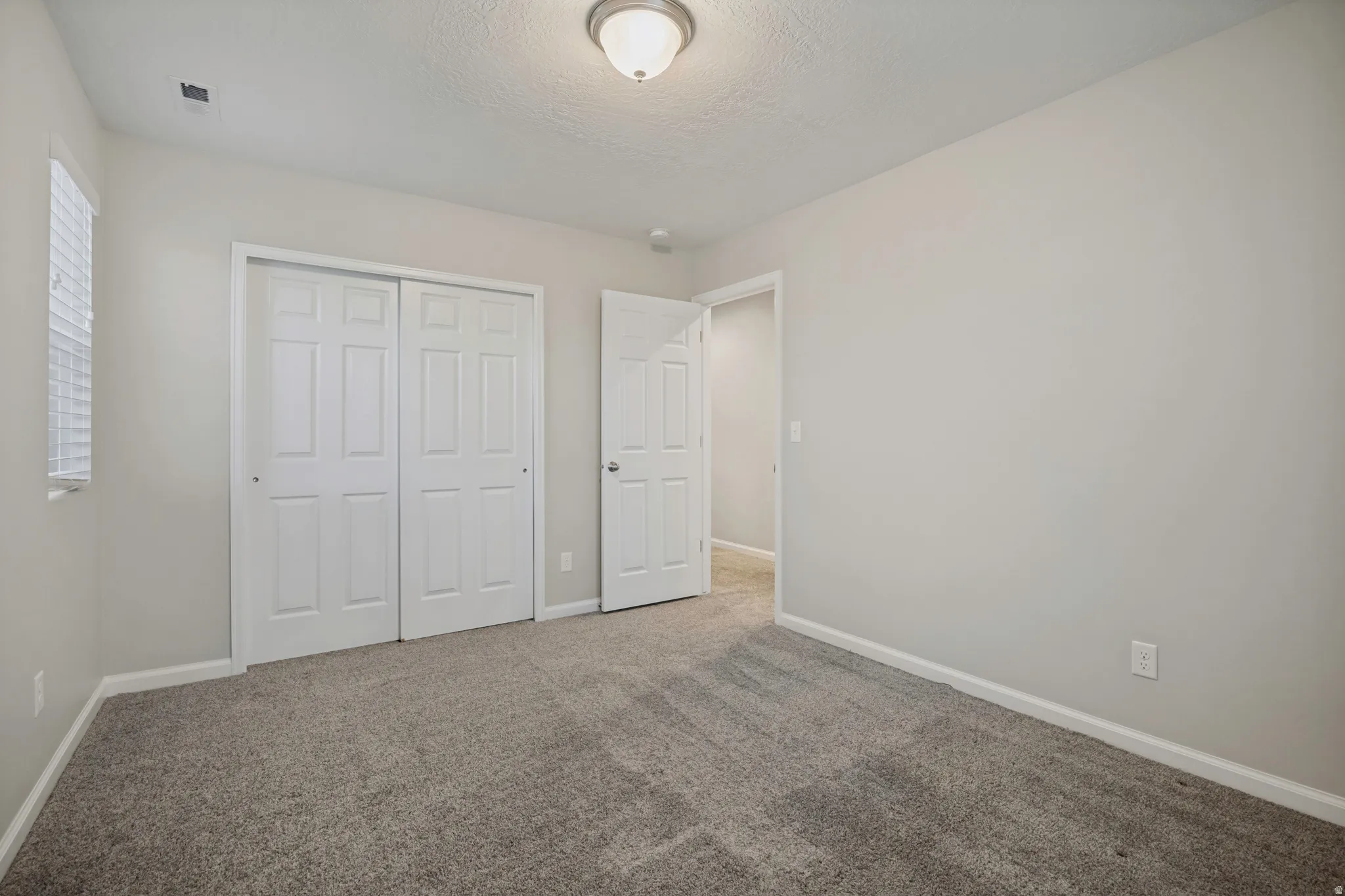 Gray carpeting throughout with light gray wall paint