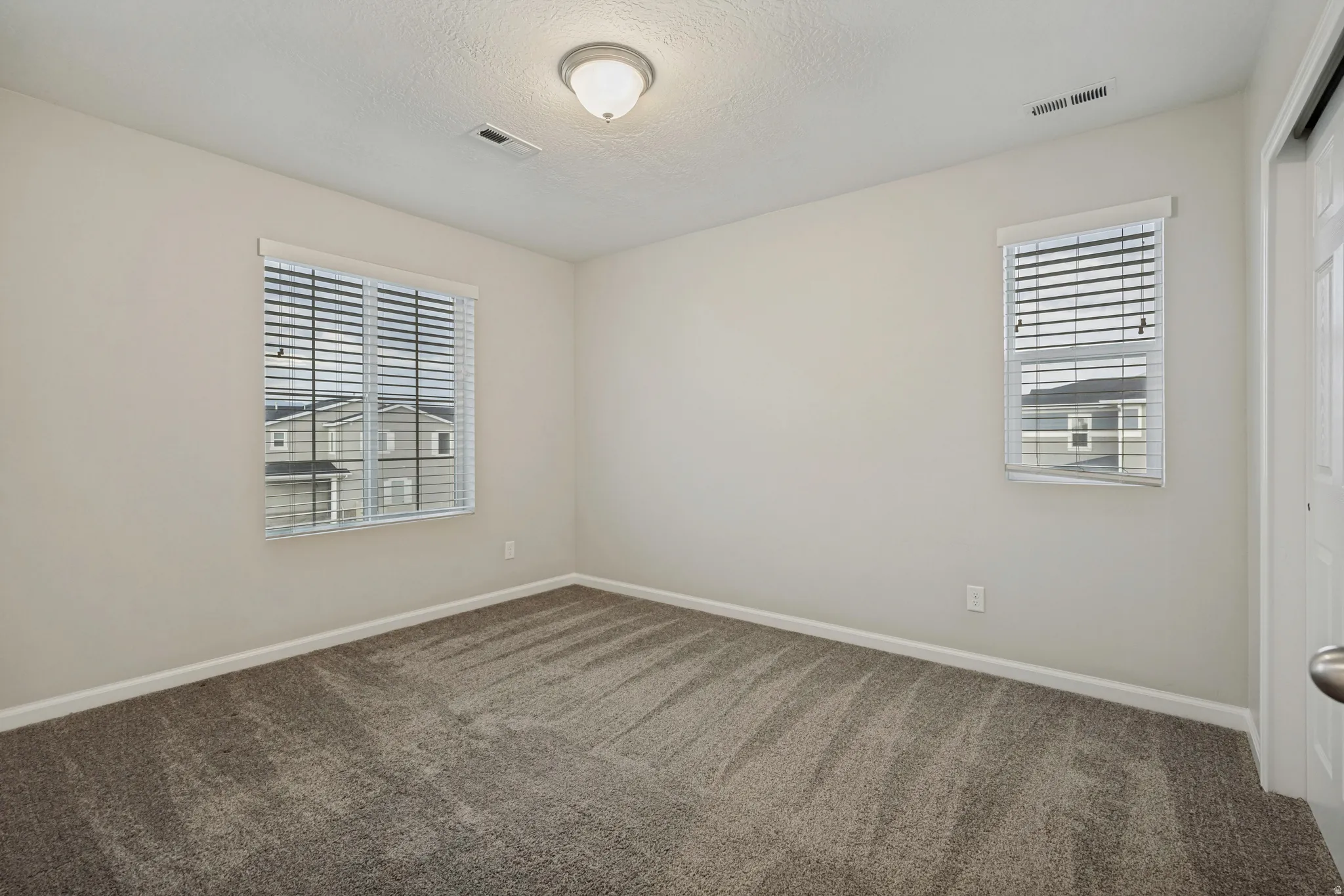 Neutral toned walls complement plush carpeting
