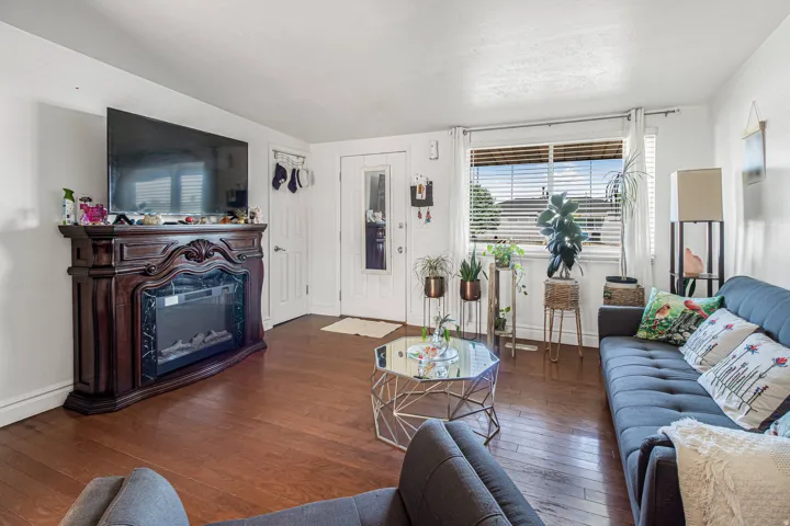 Hardwood-finish flooring throughout, featuring a decorative fireplace with a dark wood mantel