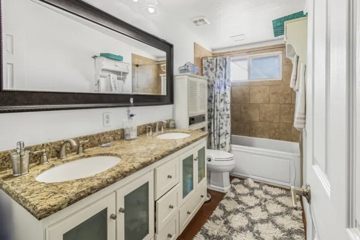 Dual vanity with stone-finish countertop and undermount sinks