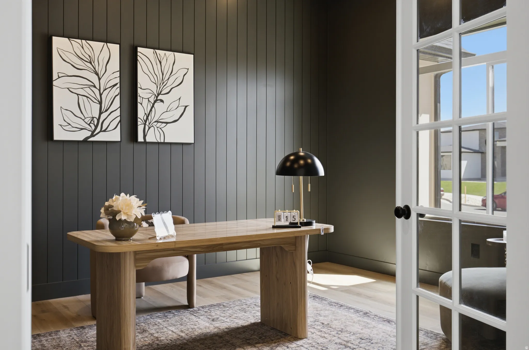 French doors with grid panels, vertical plank wall paneling, wood-finish flooring, and a built-in ceiling light fixture