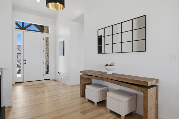 Wood-finish flooring, white walls, and a recessed ceiling light