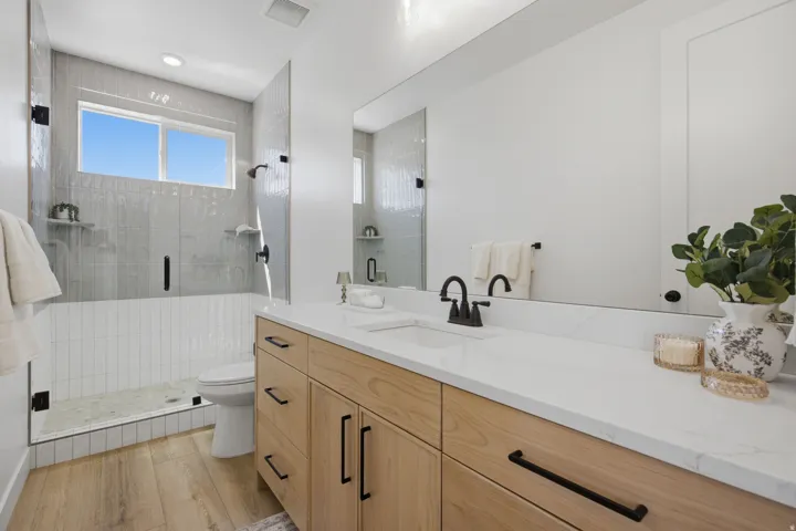 Modern vanity with wood-finish cabinetry and black hardware