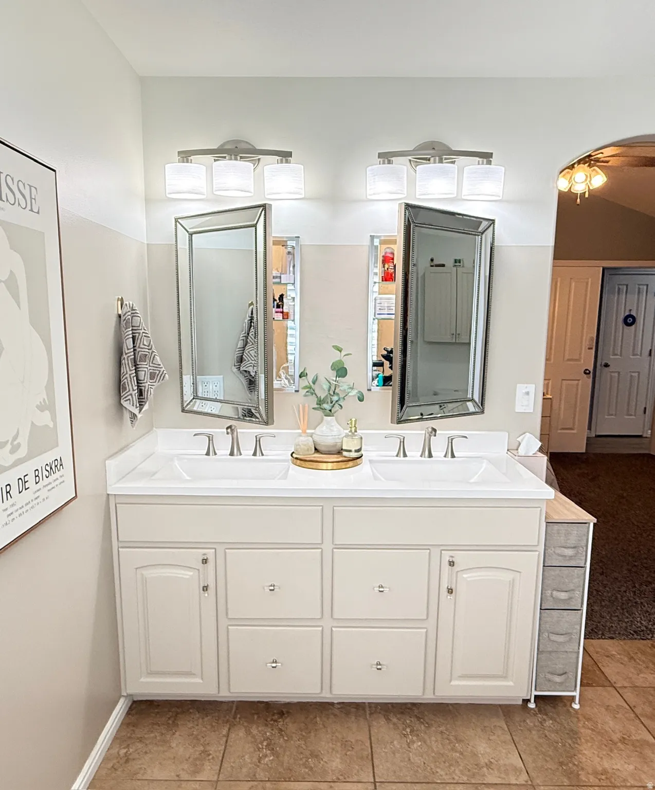 Dual vanity with white cabinetry, two undermount sinks, and chrome-finish faucets
