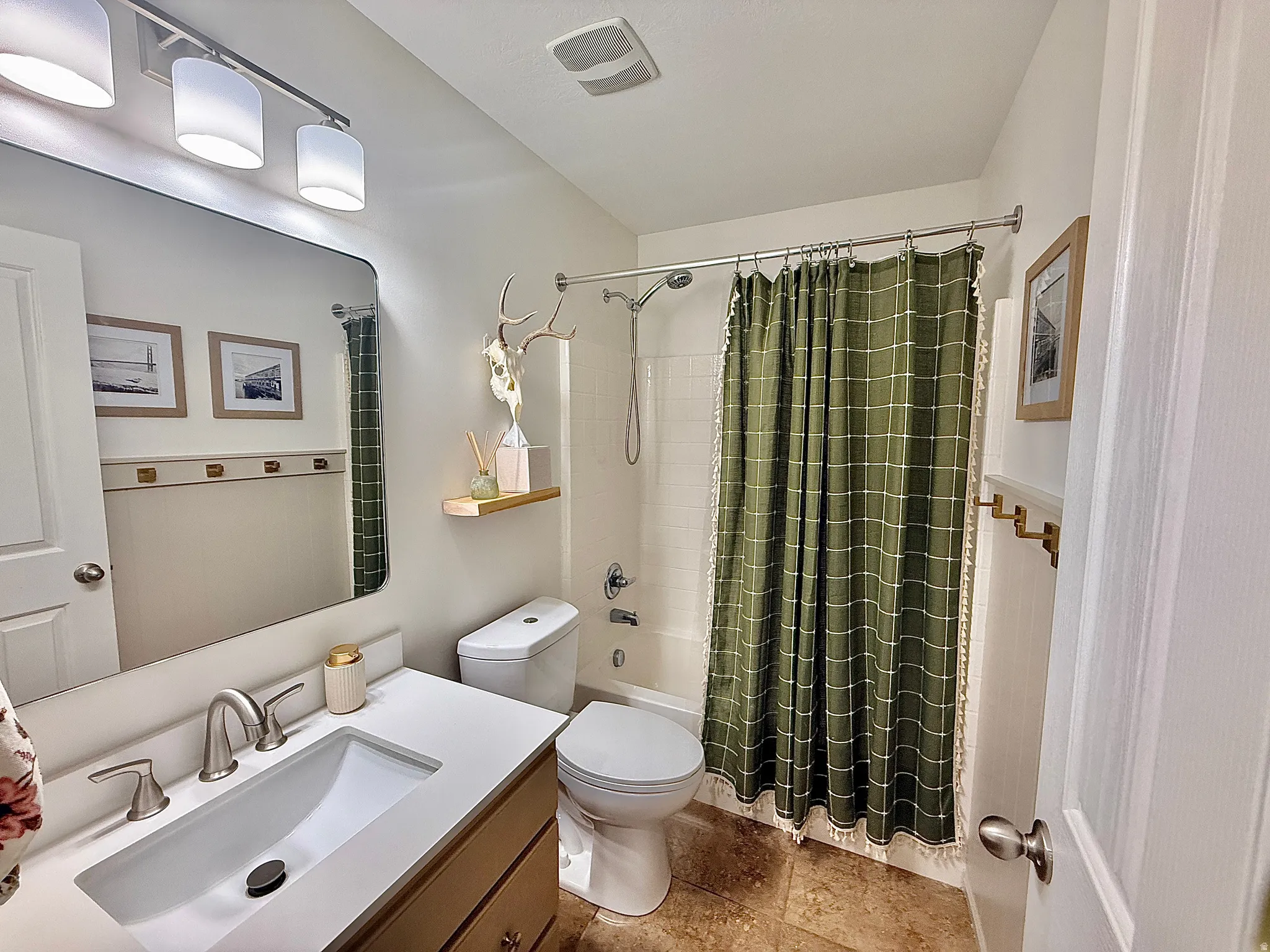 Built-in vanity with integrated sink, rectangular mirror, and three-light fixture