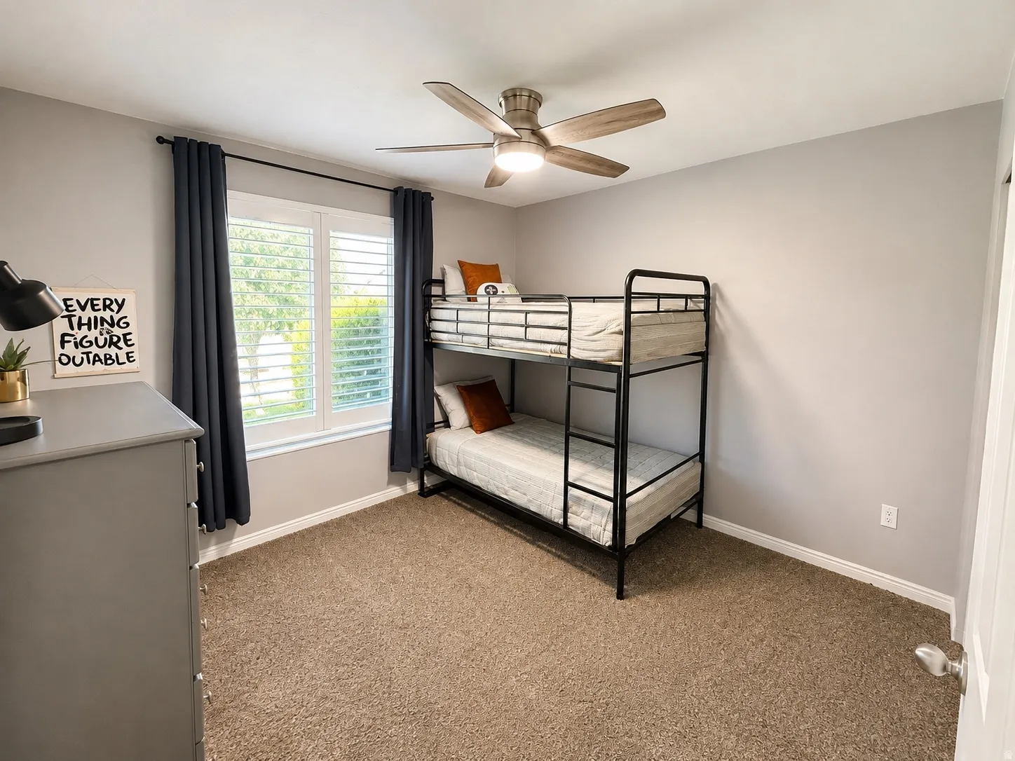 Neutral wall color, carpet flooring, window with shutters, ceiling fan with integrated lighting, white trim
