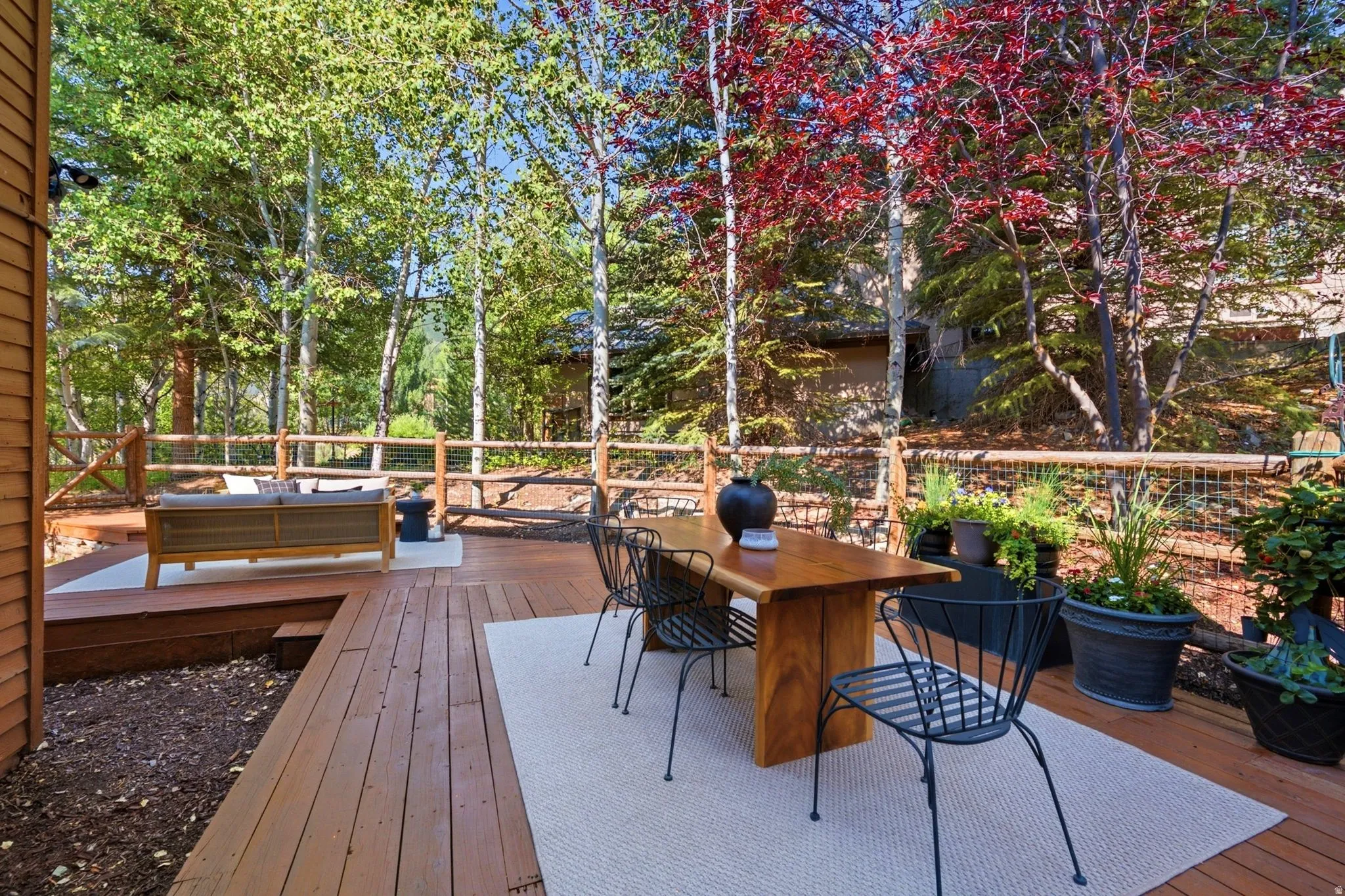 Secluded and private back deck right off the kitchen and dining room with multiple seating areas for entertaining, relaxing, working from home, and being immersed in nature.  The home often sees moose, deer, rabbits, squirrels, birds and less commonly elk