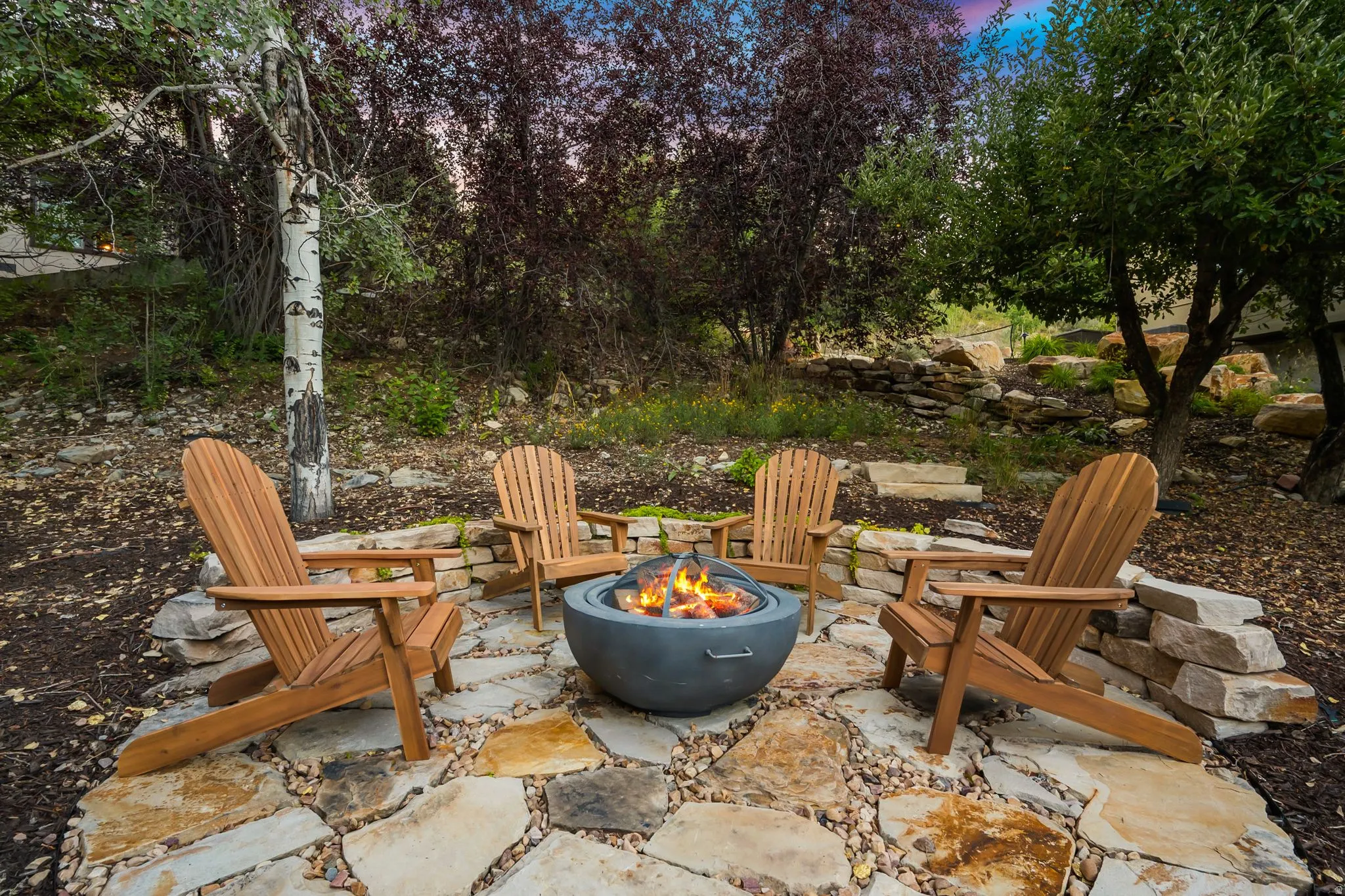 Stone paver pathway leading to a stone fire pit area in the back/side yard.  Imagine getting out the gravity chairs and taking in the stars or sunsets.