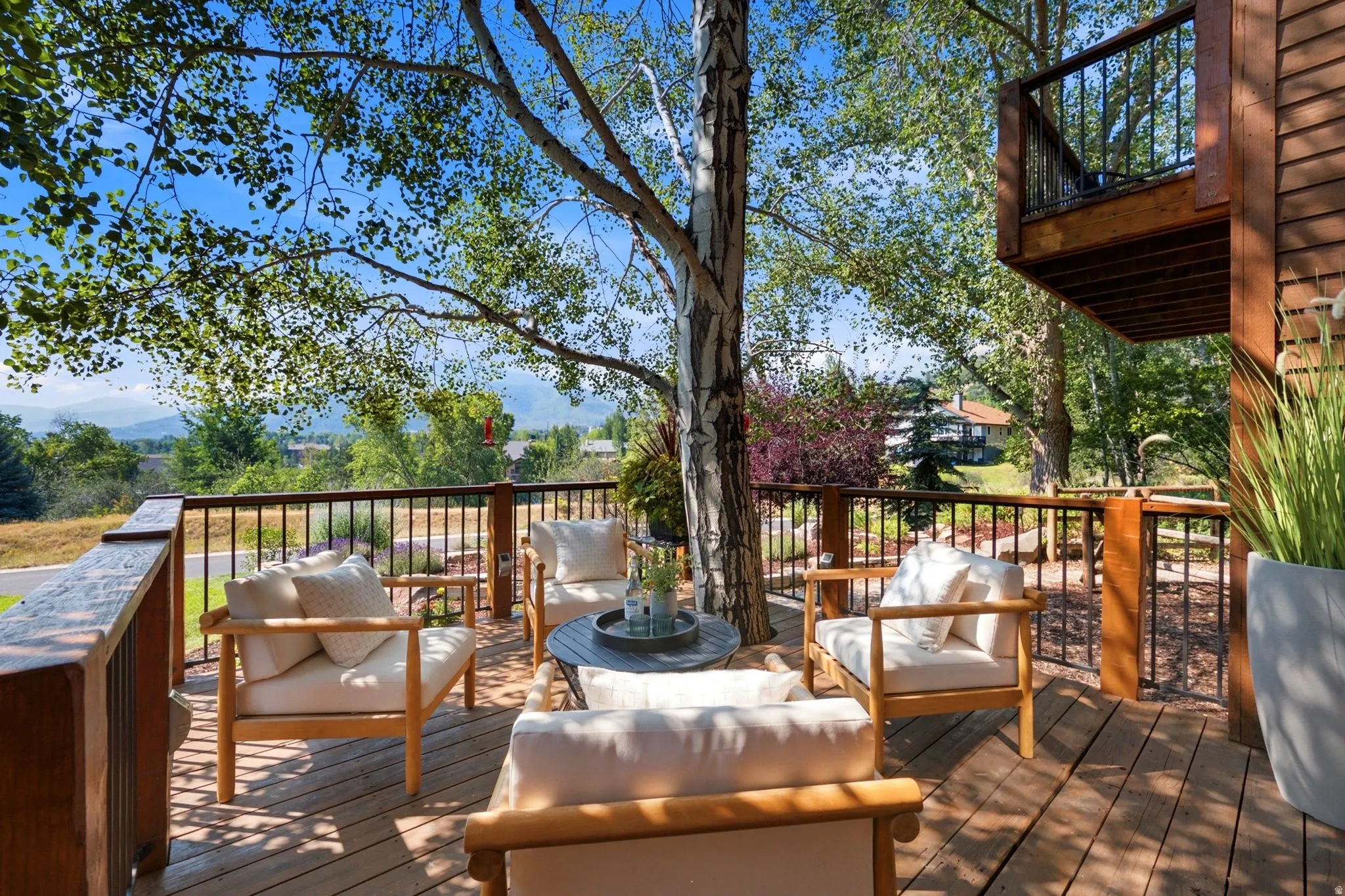 Front deck with a tree integrated into the deck and stunning views of Park City, Canyons, and Deer Valley. Imagine watching the fireworks from your front deck!