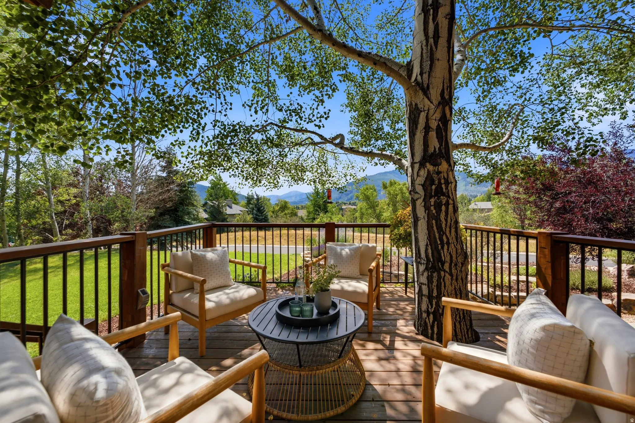 Front deck with a tree integrated into the deck and stunning views of Park City, Canyons, and Deer Valley. Imagine watching the fireworks from your front deck!