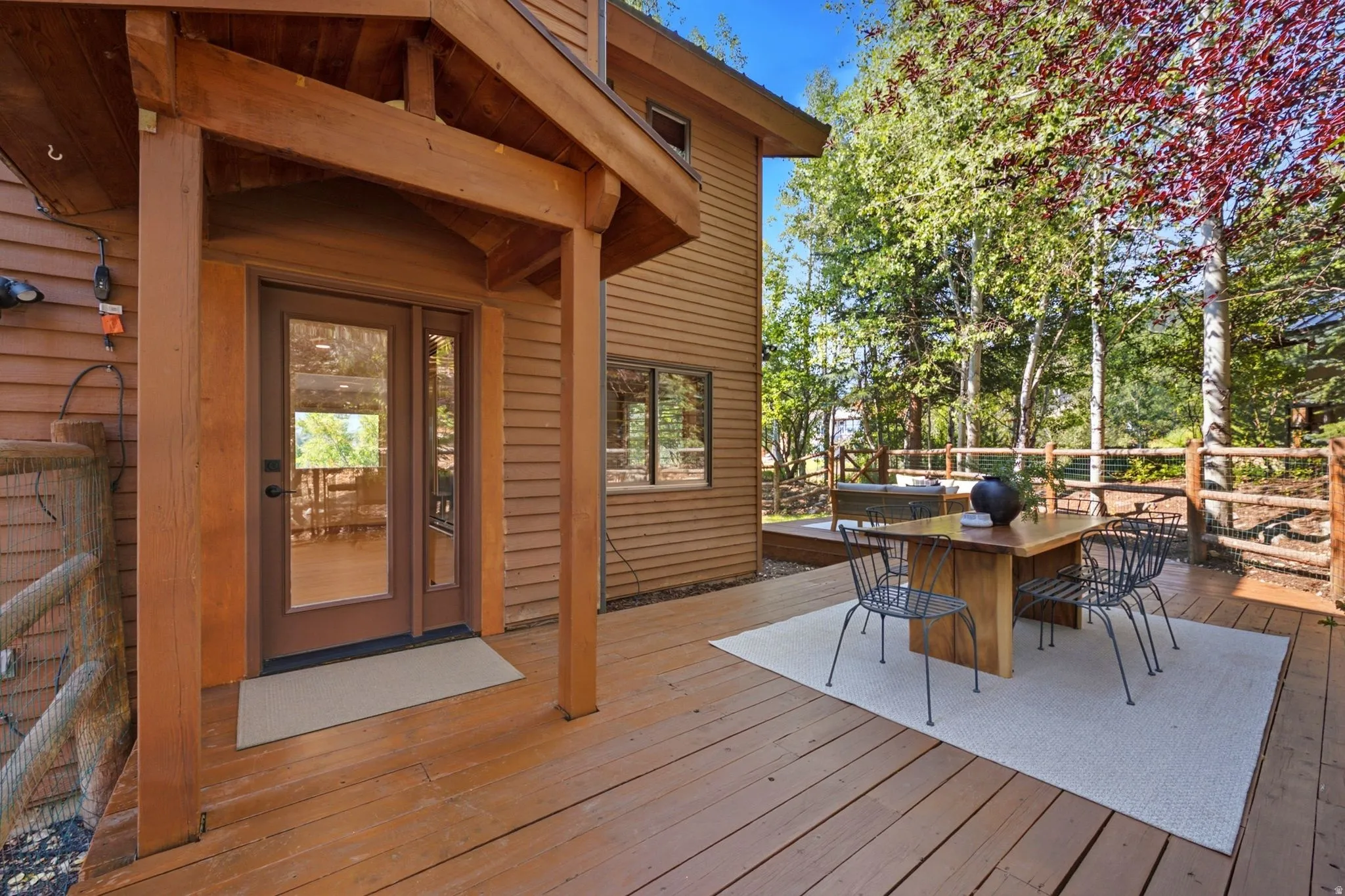 Secluded and private back deck right off the kitchen and dining room with multiple seating areas for entertaining, relaxing, working from home, and being immersed in nature.  The home often sees moose, deer, rabbits, squirrels, birds and less commonly elk