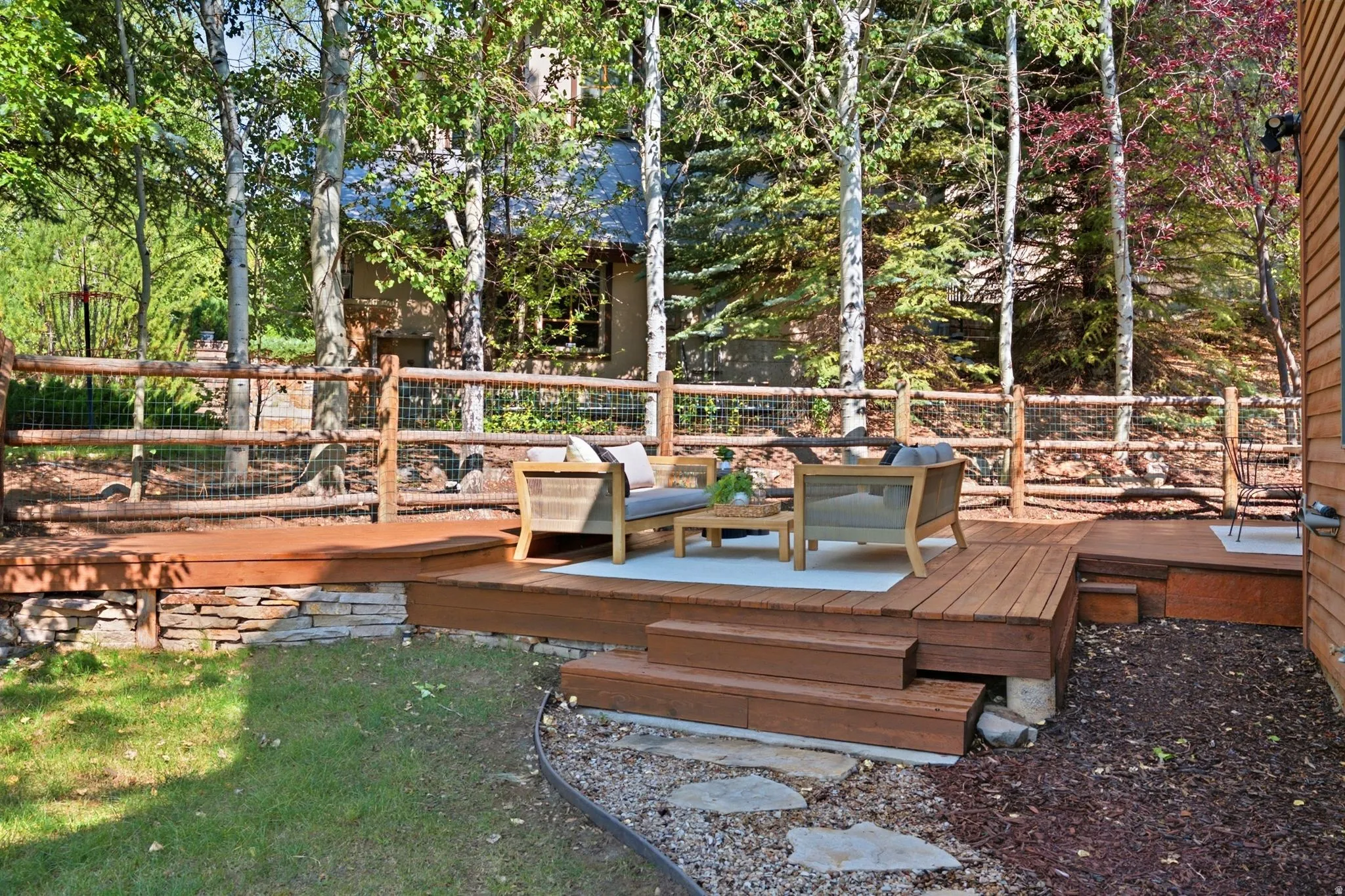 Secluded and private back deck right off the kitchen and dining room with multiple seating areas for entertaining, relaxing, working from home, and being immersed in nature.  The home often sees moose, deer, rabbits, squirrels, birds and less commonly elk