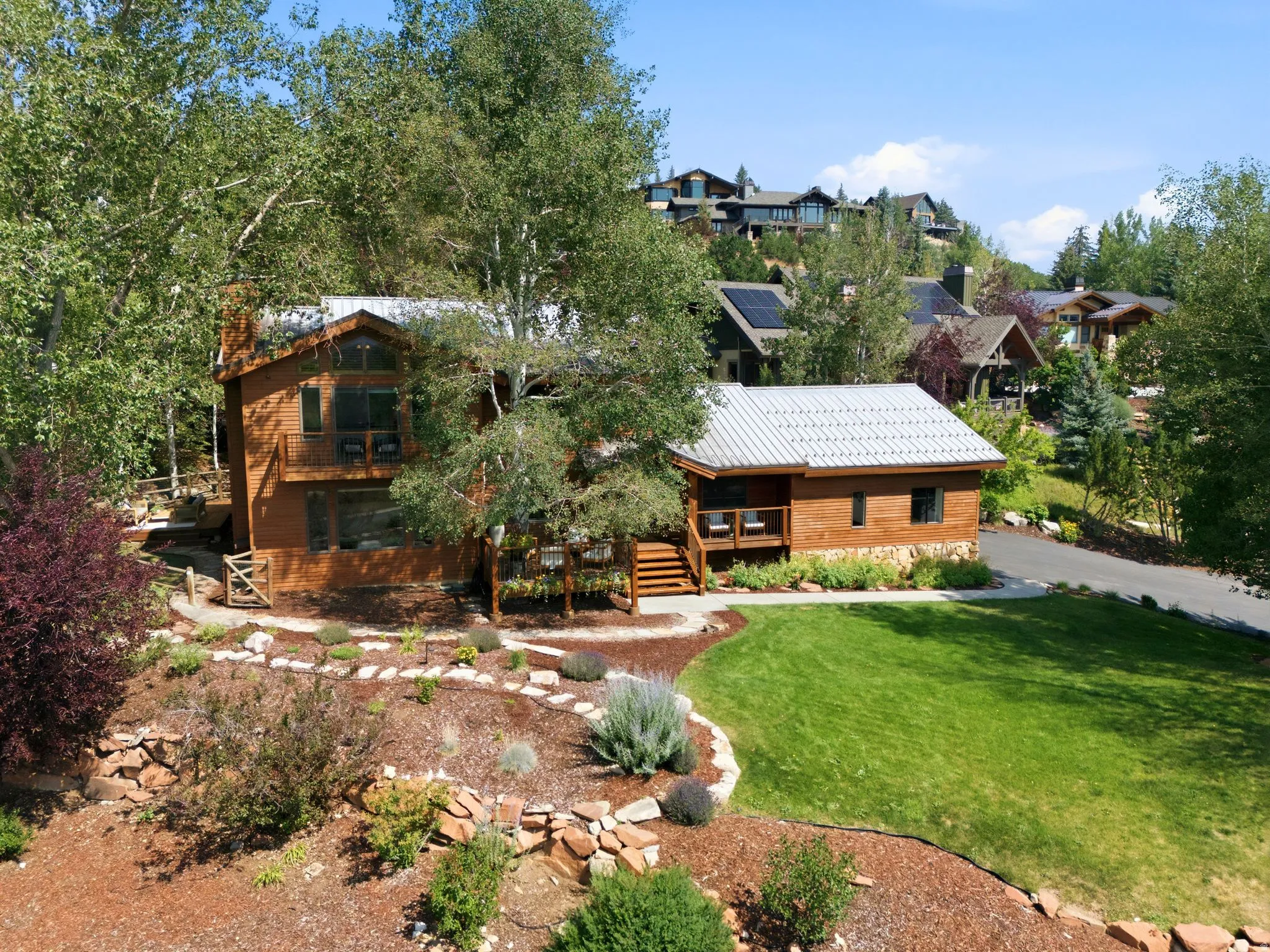 Front view of 1936 Kidd Cir. with tastefully done xeriscaping and a nice grassy area with mature trees.