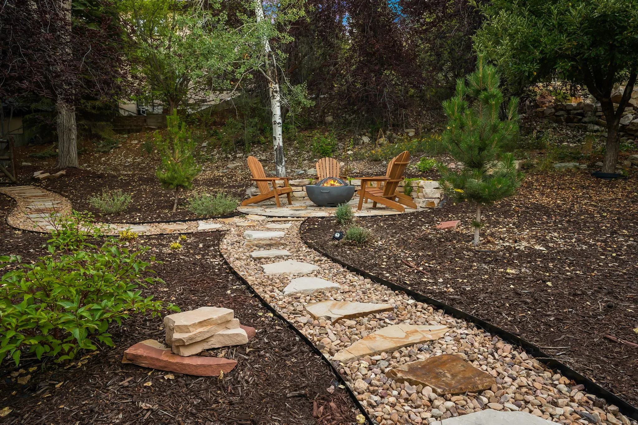 Stone paver pathway leading to a stone fire pit area in the back/side yard.  Imagine getting out the gravity chairs and taking in the stars or sunsets.
