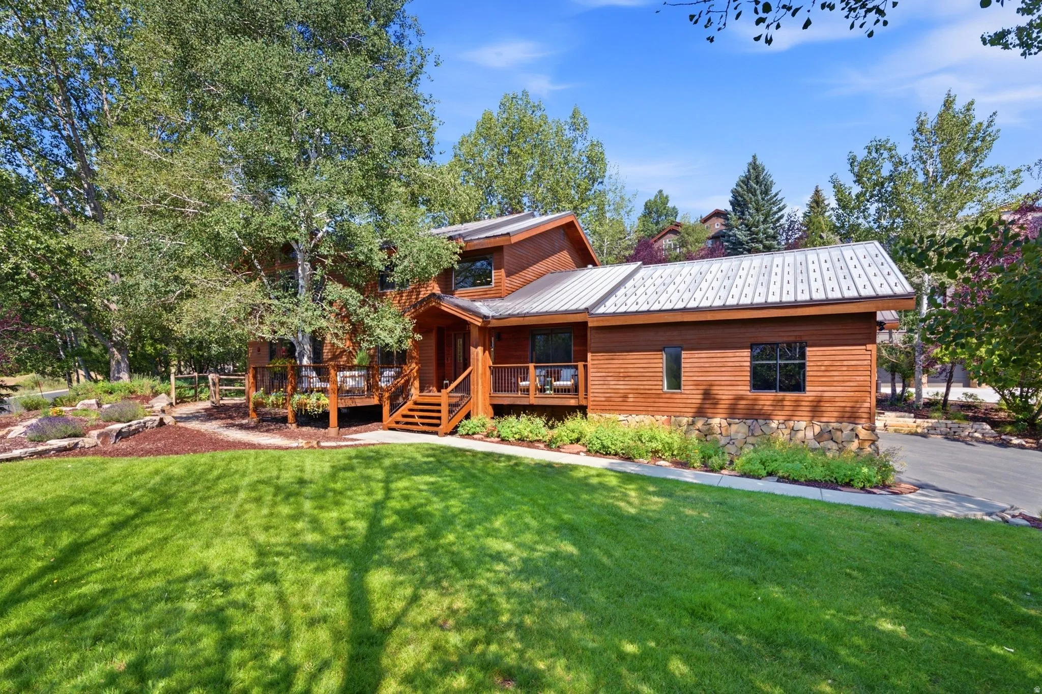 Front view of 1936 Kidd Cir. with tastefully done xeriscaping and a nice grassy area with mature trees.