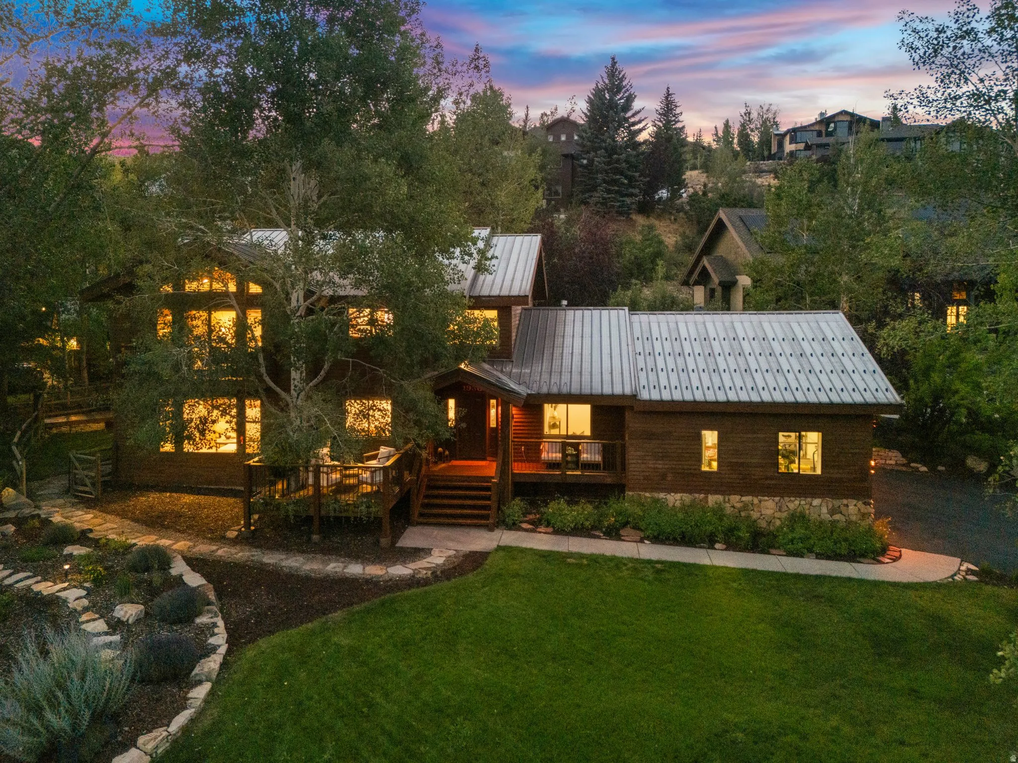 Front view of 1936 Kidd Cir. with tastefully done xeriscaping and a nice grassy area with mature trees.