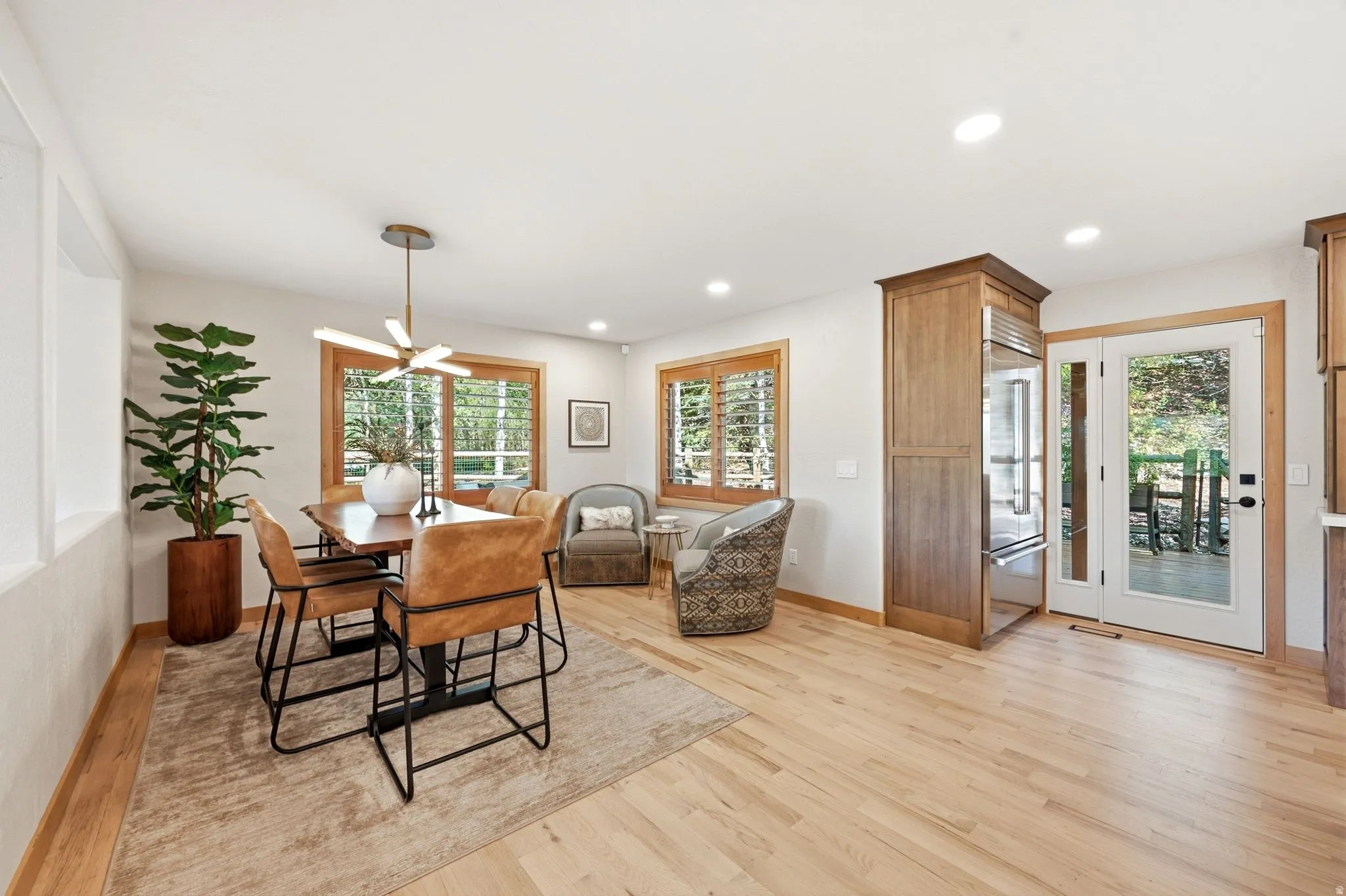 Refinished hardwood flooring extends throughout this open living space.  Easy access to the back deck and outdoor living space.  Views from your dining table.