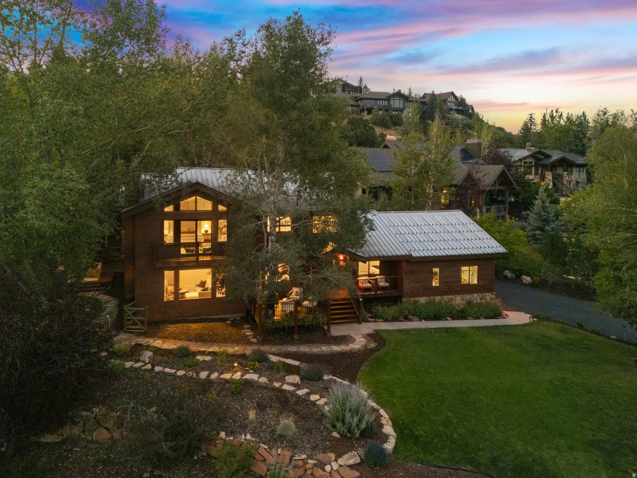 Front view of 1936 Kidd Cir. with tastefully done xeriscaping and a nice grassy area with mature trees.