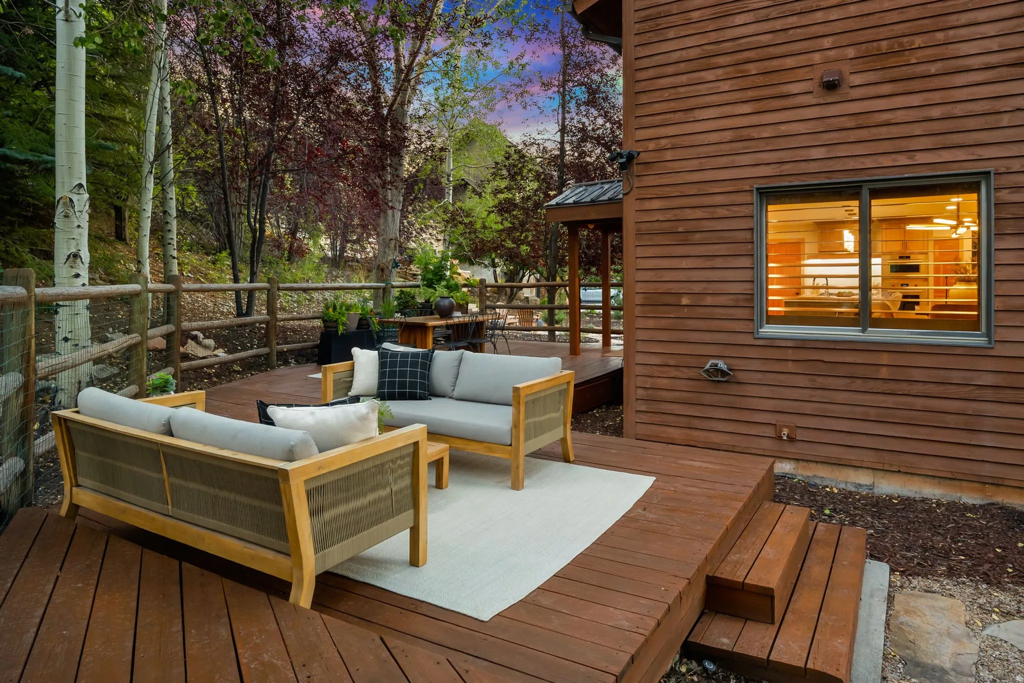 Secluded and private back deck right off the kitchen and dining room with multiple seating areas for entertaining, relaxing, working from home, and being immersed in nature.  The home often sees moose, deer, rabbits, squirrels, birds and less commonly elk