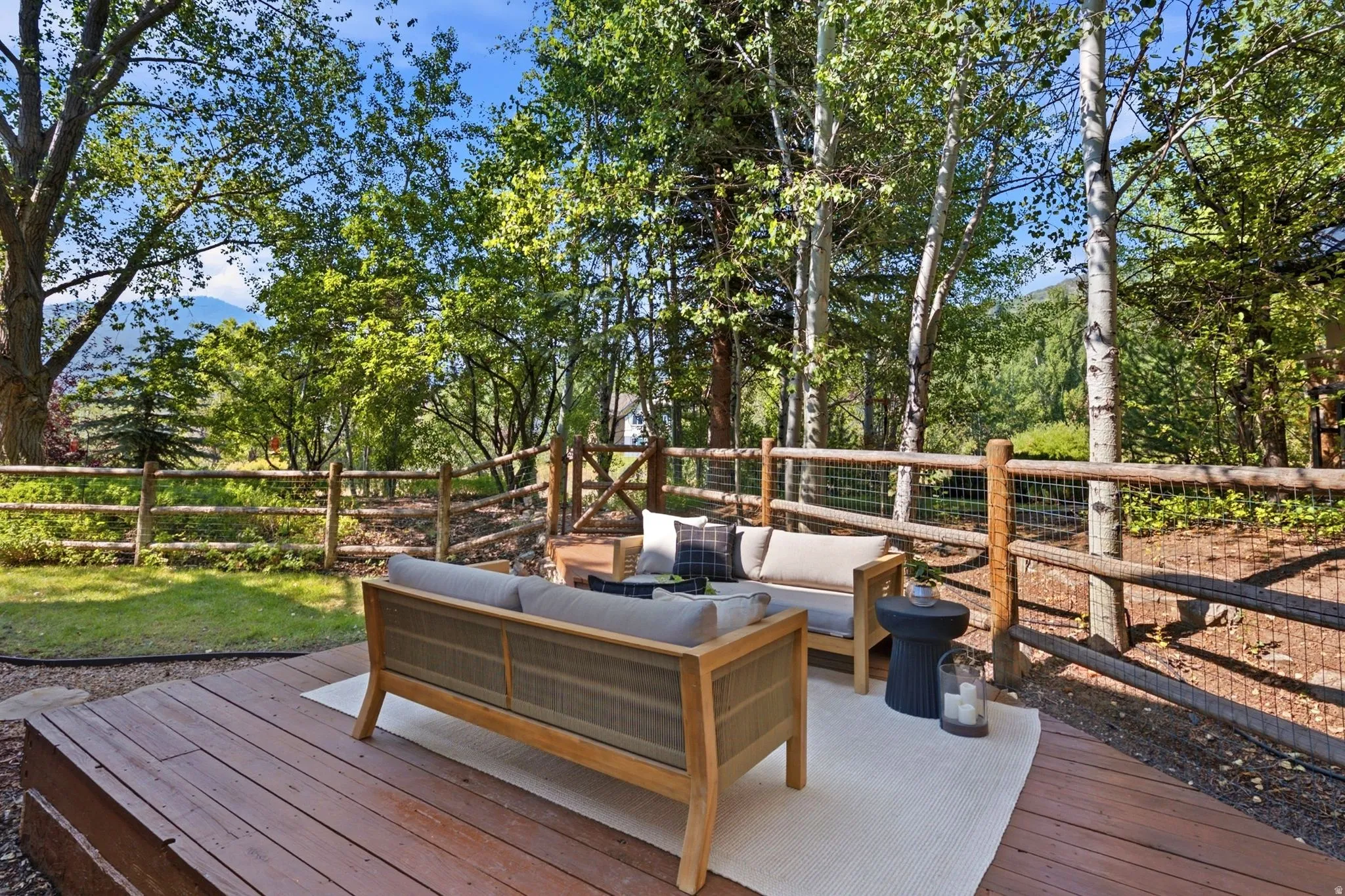 Secluded and private back deck right off the kitchen and dining room with multiple seating areas for entertaining, relaxing, working from home, and being immersed in nature.  The home often sees moose, deer, rabbits, squirrels, birds and less commonly elk