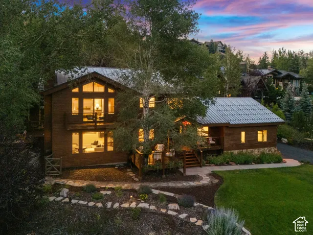 Front view of 1936 Kidd Cir. with tastefully done xeriscaping and a nice grassy area with mature trees.