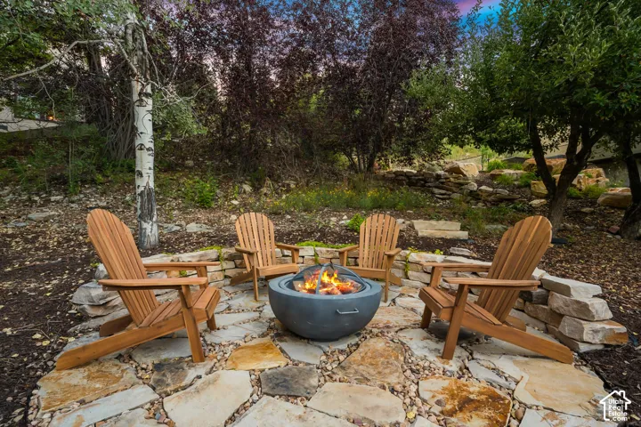 Stone paver pathway leading to a stone fire pit area in the back/side yard.  Imagine getting out the gravity chairs and taking in the stars or sunsets.