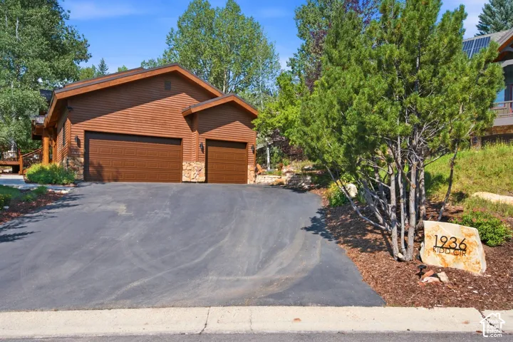Three-car garage with ample storage areas and additional storage above.  Ample off street driveway parking and driveway parking still allows access to the garage doors.