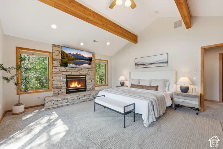 Primary bedroom with vaulted ceilings, fireplace, a private deck, incredible views of the mountains and ski resorts, an en-suite bathroom with a separate jetted tub and shower, heated floors and a walk-in closet.