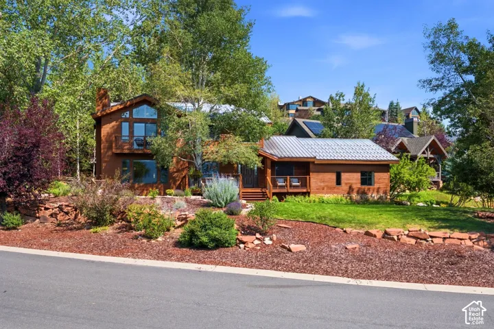 Front view of 1936 Kidd Cir. with tastefully done xeriscaping and a nice grassy area with mature trees.