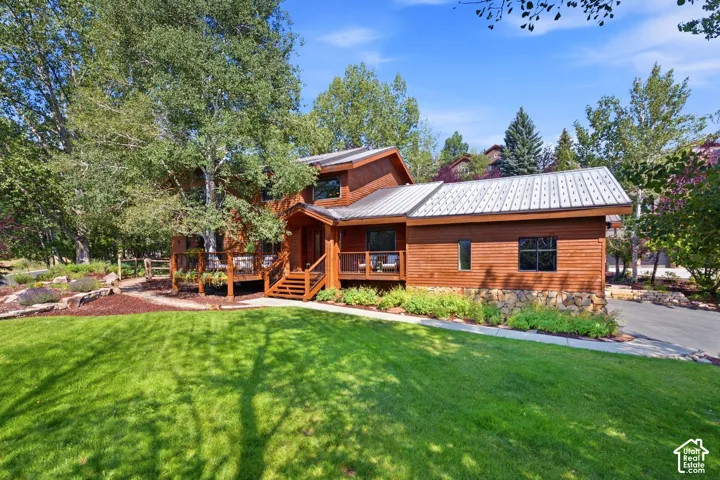 Front view of 1936 Kidd Cir. with tastefully done xeriscaping and a nice grassy area with mature trees.