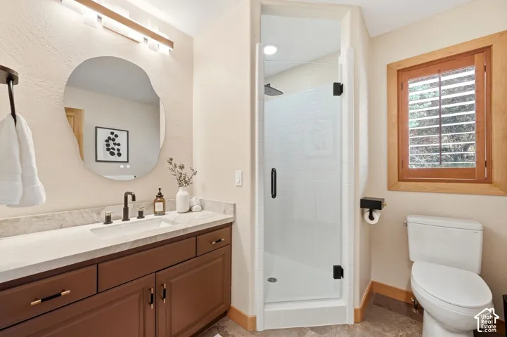 The first-level three-quarter bathroom has been fully updated and has heated floors and Taj Mahal quartzite countertops.