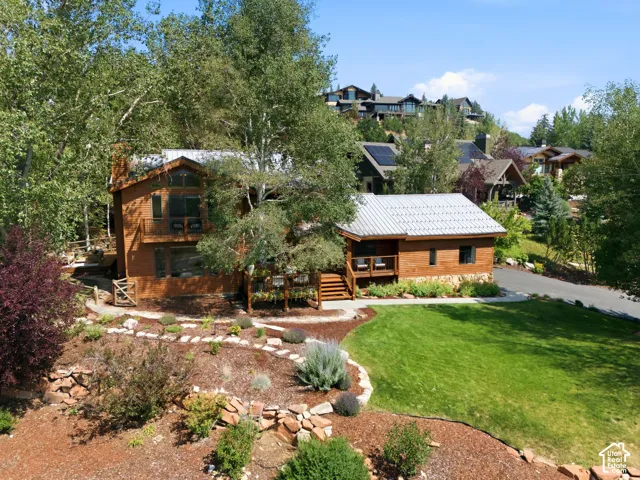 Front view of 1936 Kidd Cir. with tastefully done xeriscaping and a nice grassy area with mature trees.