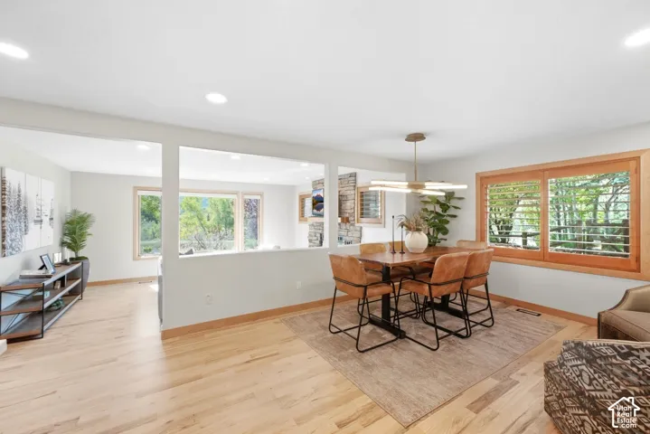 Recessed lighting, wood-finish flooring, wood-framed windows with plantation shutters, contemporary chandelier