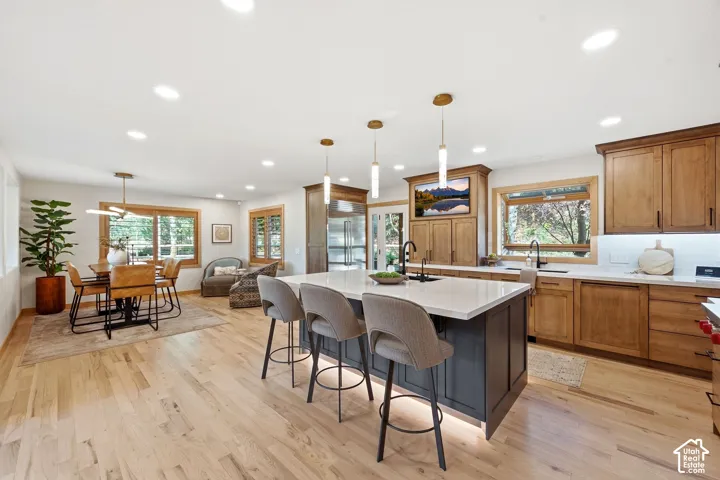 Open-concept kitchen and dining area with ample natural light.  Refinished wood flooring, updated lighting.